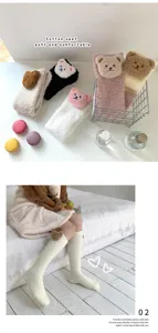 Detailaufnahme weicher Korallenfleece-Socken mit süßen, flauschigen Bären-Patches.