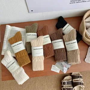Detailed macro view of cable knit slouch socks in a variety of earthy retro colors