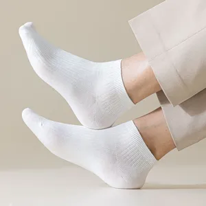 Close-up of white men's low cut boat socks showing fine rib texture and snug fit.