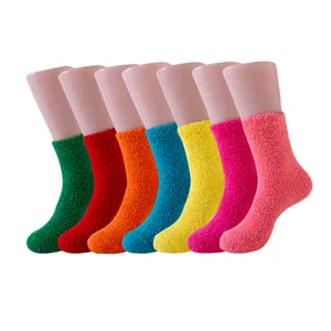 Variety of vibrant candy-colored coral fleece sleep socks shown on display mannequins
