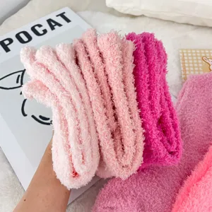 Soft coral fleece socks in pink shades showing thick fuzzy texture for cold winter.