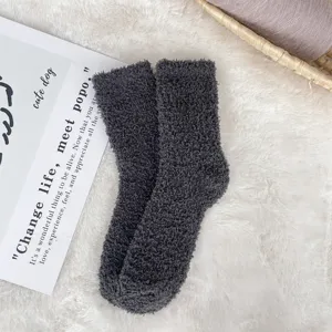 Macro view of soft charcoal grey coral fleece sleep socks providing cozy winter warmth