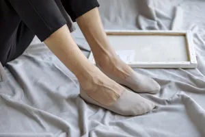 Detaillierte Nahaufnahme beige unsichtbare Herren-Füßlinge am Fuß mit nahtlosem Design