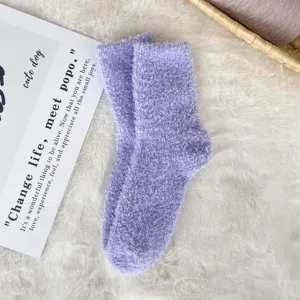 Close-up of soft purple fuzzy coral fleece socks featuring a thick plush texture