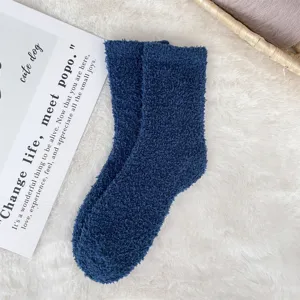 Macro detail of cozy navy blue coral fleece sleep socks showing soft fuzzy texture