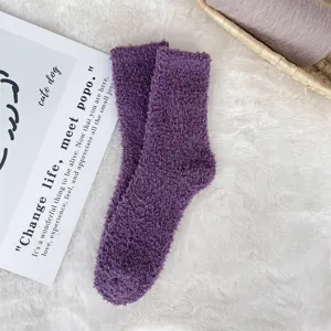Close-up of cozy purple coral fleece fuzzy socks with soft plush texture for winter