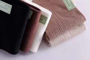 Close-up of four pairs of thin breathable cotton men's boat socks in various colors