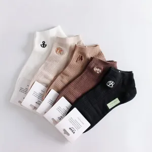 Detailed view of men's low-cut cotton boat socks with various embroidery motifs