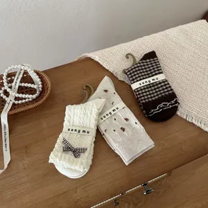 Detail view of vintage Japanese style women's socks with bow and floral patterns