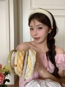 Close-up of stylish yellow high-skull-top headbands set shown by an Asian model