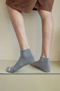 Detailed view of grey men's low-cut ribbed socks showing premium fabric texture