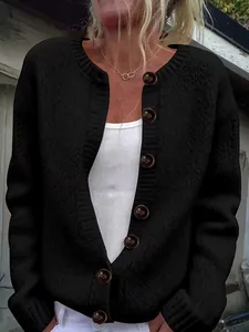 Close-up detail of women's loose black knitted cardigan featuring vintage brown buttons