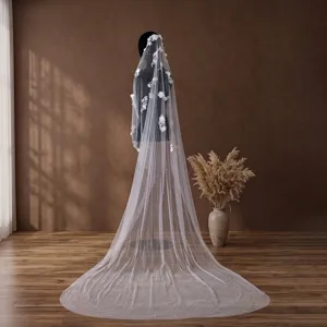 Detail of a 3-meter cathedral wedding veil with 3D floral appliqués and pearls