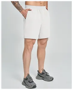 Detail view showing the fit and length of light grey men's athletic performance shorts
