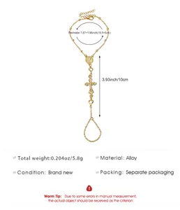 Gold-toned alloy slave bracelet featuring a Virgin Mary medallion and a cross pendant.