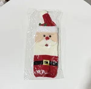 Festive knitted Santa Claus wine bottle cover for Christmas table decor in plastic bag