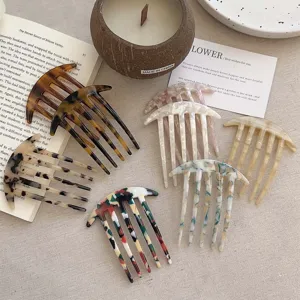 Set of elegant acetate hair combs with various marble and tortoiseshell patterns.