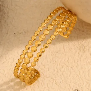 Close-up view of the 18K gold plated stainless steel triple layer disk bracelet design.