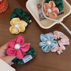 Set of elegant vintage floral scrunchies featuring large pearl centers in assorted soft colors