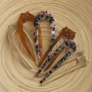 Acetate cat-shaped U-shaped hair forks in various tortoiseshell and marble patterns
