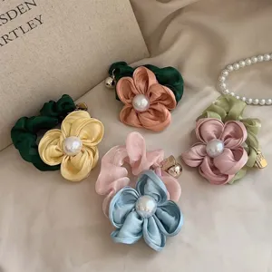 Elegant floral hair scrunchies with large pearl center in assorted vintage colors.