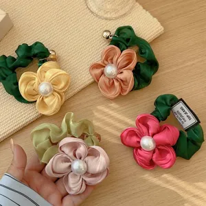Vintage style fabric flower scrunchies with large pearls for elegant ponytail styling