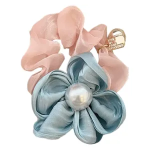 Elegant pink and blue silk-like flower scrunchie with a large white pearl center