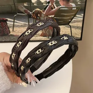 Elegant braided leather headband with gold chain details, stylish hair accessory for women