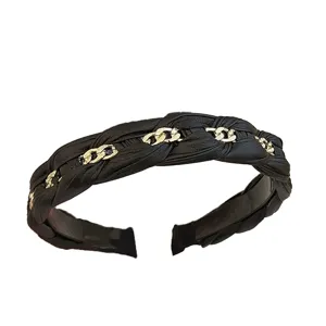 Elegant black braided leather headband with gold chain details and high top design
