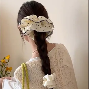 Oversized polka dot lace scrunchie shown in a stylish braided hair look for daily use