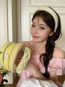 Model wearing and holding sweet cream yellow French style high top textured headbands
