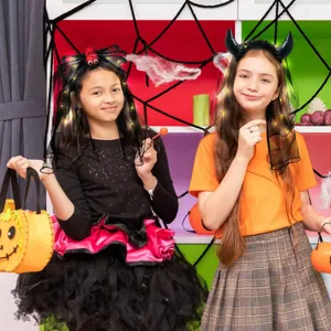 Detailed shot of kids wearing glowing Halloween headbands with spider and devil horn veils