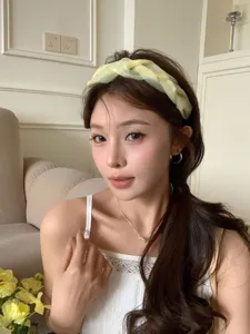 Elegant yellow braided wide headband for high top hairstyle shown on Asian model