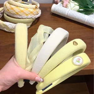 Collection of fashionable high-crown yellow and white wide fabric headbands for daily wear
