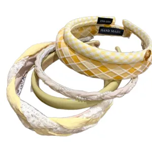 Set of stylish yellow and white headbands with plaid, pearls, and lace designs