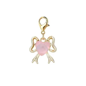 Detailed view of a pink heart and gold bow jewelry charm with a secure lobster clasp