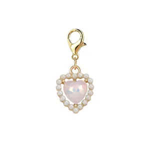 Close-up detail of a pink heart charm pendant with small pearl border