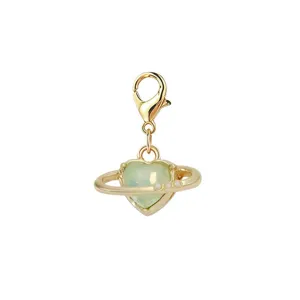 Detail view of a gold-plated heart planet charm with a green stone and lobster clasp