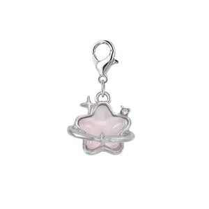 Close-up of a pink star charm with lobster clasp featuring a cute planet ring design
