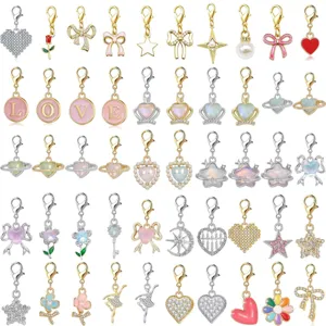 Collection of lobster clasp charms with heart, bow, and star designs for DIY jewelry