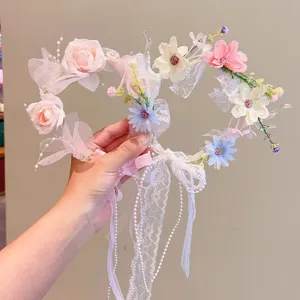 Delicate fairy floral headband featuring pink roses, lace streamers and pearl details