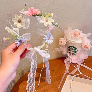 Detail shot of white lace floral headband with fairy-style ribbons and pearl decor