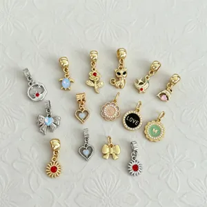 Collection of colorful DIY jewelry charms including heart, bow, and celestial designs