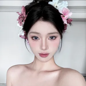 Close-up of realistic cymbidium orchid hair clips worn by a model in soft style