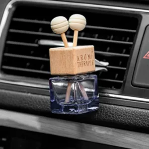 Car air vent perfume bottle diffuser detail view, stylish wooden cap with dual diffusion sticks.