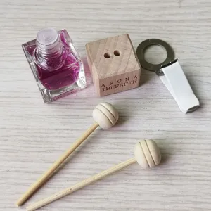 Car air freshener perfume bottle detail, 8ml square glass bottle with wooden diffuser cap and clip.