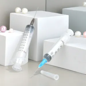 Perfume dispenser syringe detail view, transparent plastic tube with clear measurement scales.