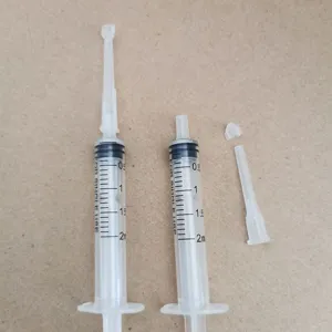 Plastic perfume dispenser syringe detail, 2.5ml clear graduated tool with nozzle and cap.
