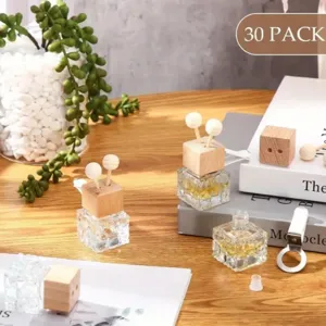 Detailed view of square glass car perfume diffuser bottles with wooden caps and sticks.