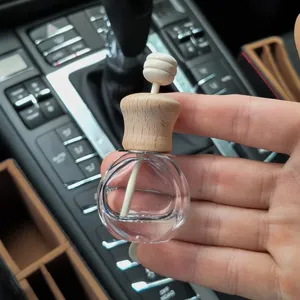 Car perfume diffuser glass bottle with wooden cap and diffuser stick for auto interior.